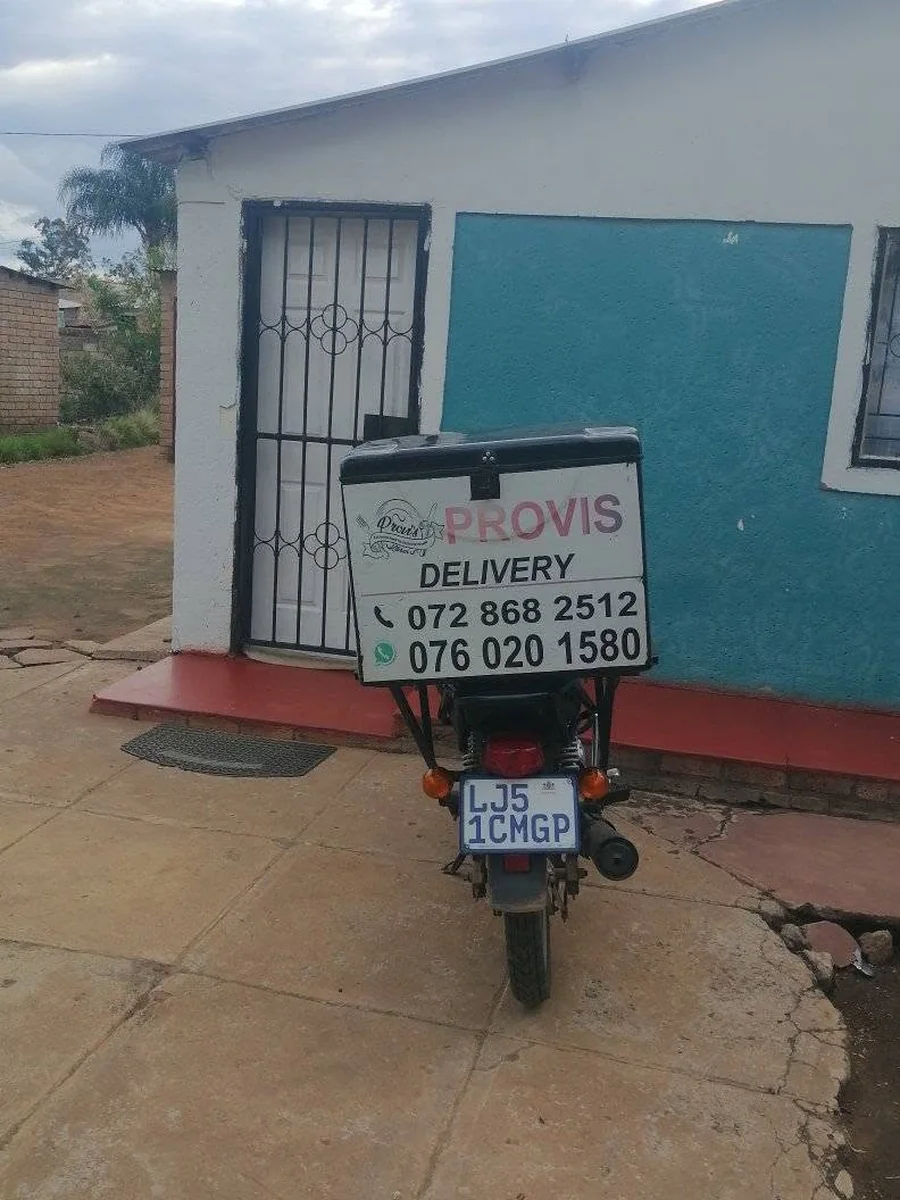 Provis Kitchen delivery motorcycle displaying the business telephone and WhatsApp numbers