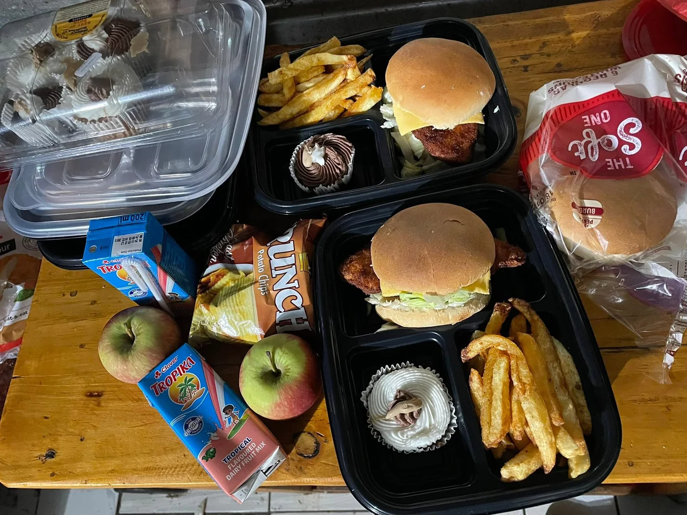 Provis Kitchen school and workplace lunchboxes with burgers, chips, fruit, juice and cupcakes